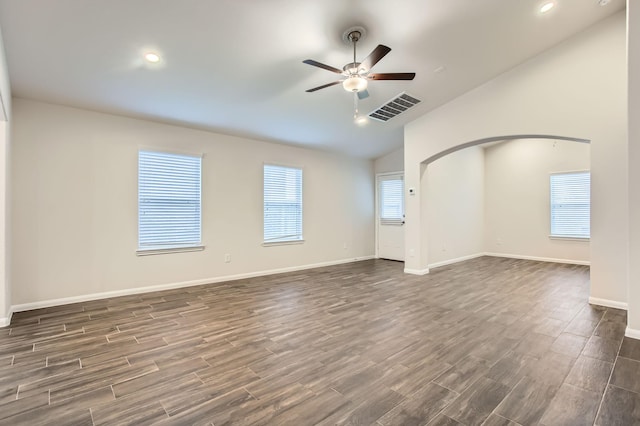 7535 Cypress Pin Oak Dr, Cypress, TX 77433 - empty room featuring a ceiling fan, dark wood-style floors, vaulted ceiling, and visible vents
