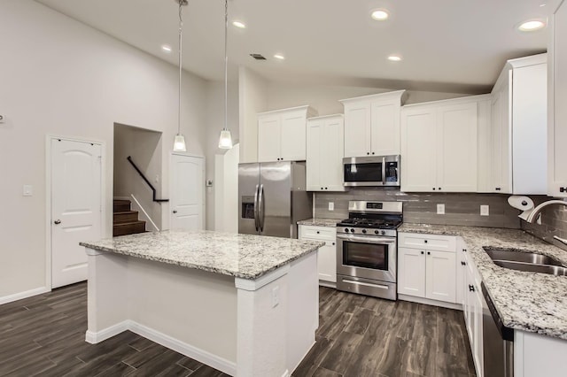 kitchen with white cabinets, appliances with stainless steel finishes, and a kitchen island