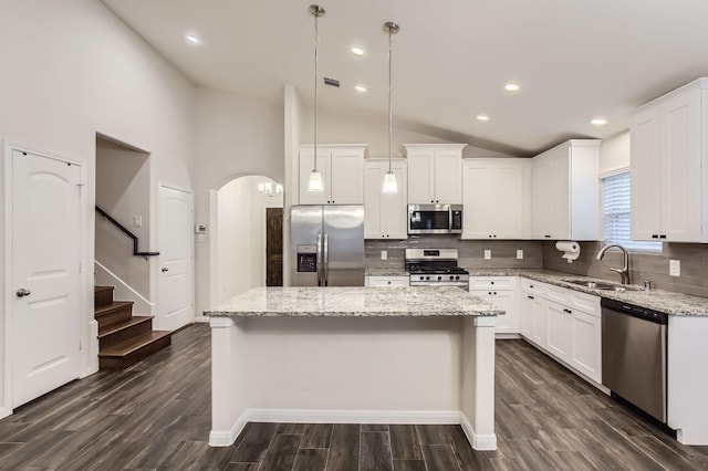 7535 Cypress Pin Oak Dr, Cypress, TX 77433 - kitchen featuring lofted ceiling, a center island, dark wood finished floors, a sink, and appliances with stainless steel finishes