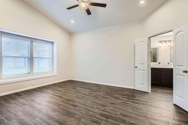 unfurnished bedroom featuring ceiling fan, ensuite bathroom, and lofted ceiling