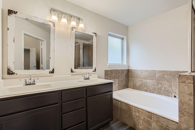 bathroom with hardwood / wood-style floors, vanity, and independent shower and bath