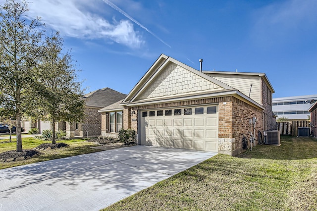 view of front of house featuring a garage, a front yard, and central AC unit