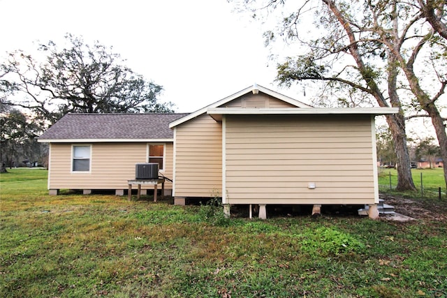 view of home's exterior featuring central air condition unit and a yard