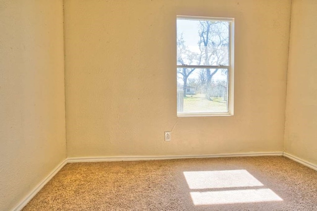 carpeted spare room with baseboards