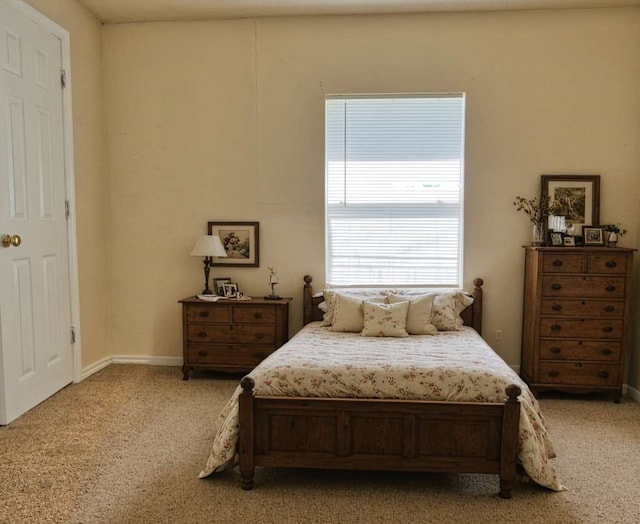 bedroom featuring baseboards and light colored carpet