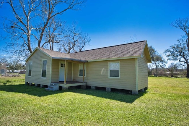 view of front of property with a front yard and roof with shingles