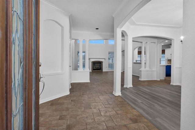 foyer entrance with ornamental molding and decorative columns