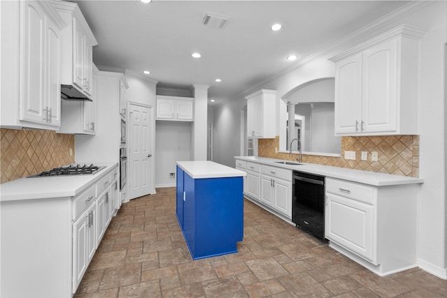 kitchen with a kitchen island, sink, white cabinets, and black appliances