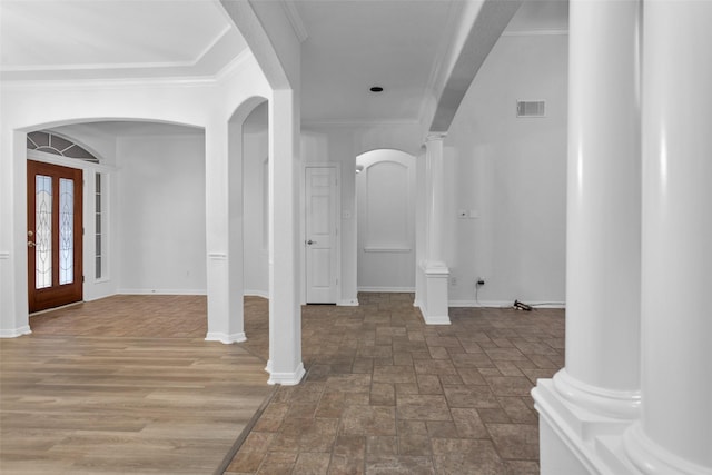 foyer with crown molding and french doors