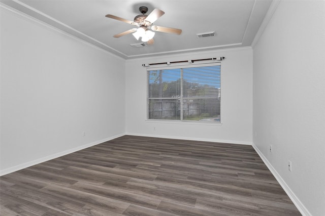 spare room with ceiling fan, dark hardwood / wood-style flooring, and ornamental molding