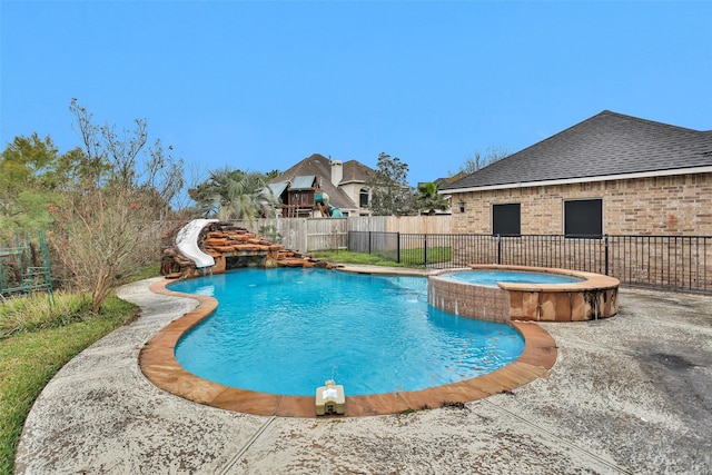 view of pool with an in ground hot tub, a patio area, and a water slide