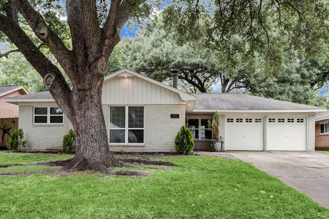 view of front facade with a front yard and a garage