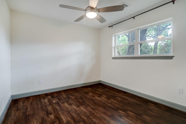 unfurnished room with ceiling fan and dark hardwood / wood-style floors