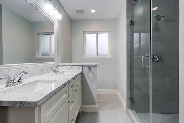 bathroom featuring an enclosed shower, vanity, and tile patterned floors