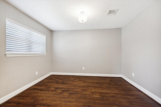 empty room with dark hardwood / wood-style floors