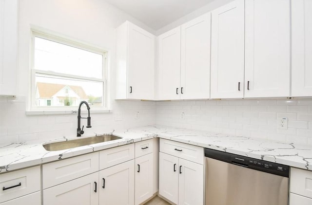 kitchen with dishwasher, decorative backsplash, sink, white cabinets, and light stone counters