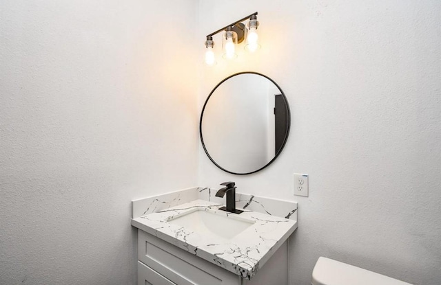 bathroom with toilet and vanity