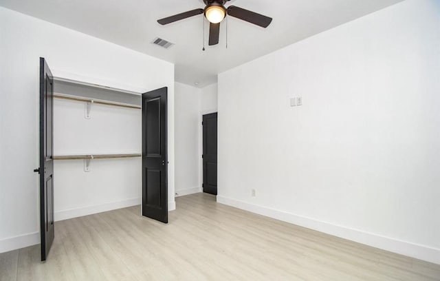 unfurnished bedroom with ceiling fan, a closet, and light hardwood / wood-style flooring