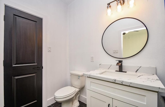 bathroom featuring toilet and vanity