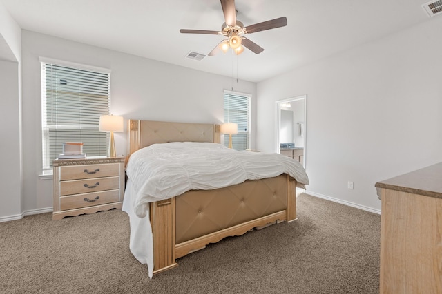 bedroom featuring ceiling fan, carpet floors, and ensuite bath