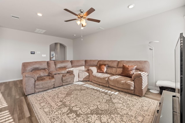 living room featuring ceiling fan and wood-type flooring