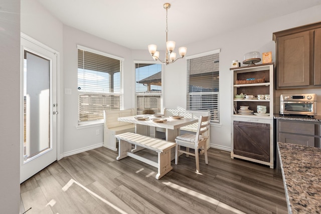 dining space with a chandelier and wood-type flooring