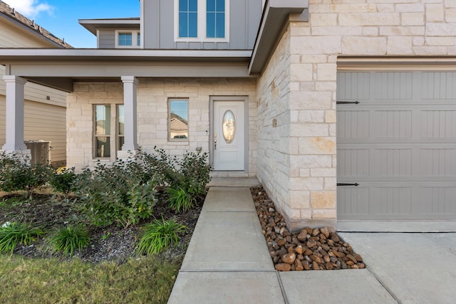 view of exterior entry with a garage