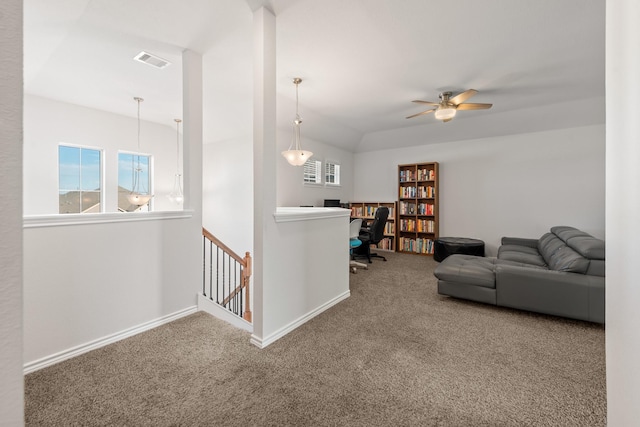 living room with ceiling fan, vaulted ceiling, and carpet