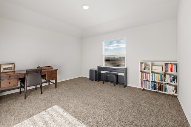 carpeted office with lofted ceiling