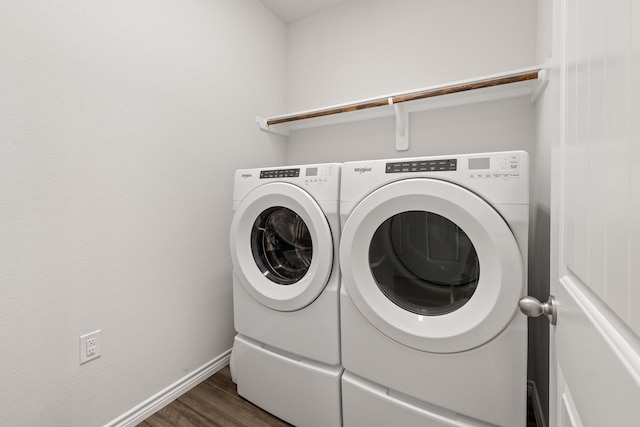 washroom with dark hardwood / wood-style flooring and washer and dryer