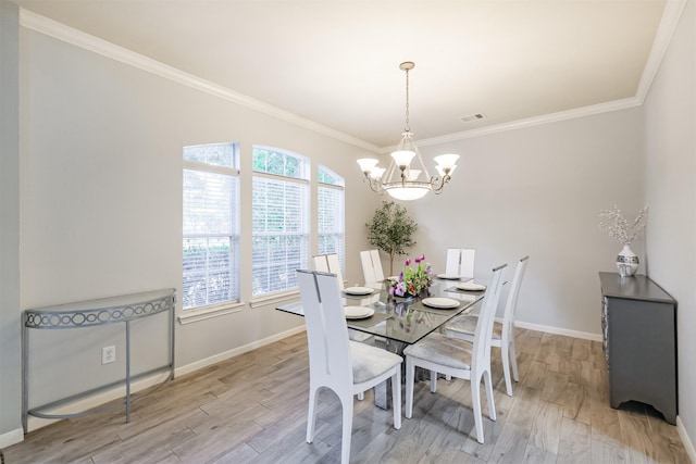 dining area featuring a chandelier, crown molding, and light hardwood / wood-style flooring