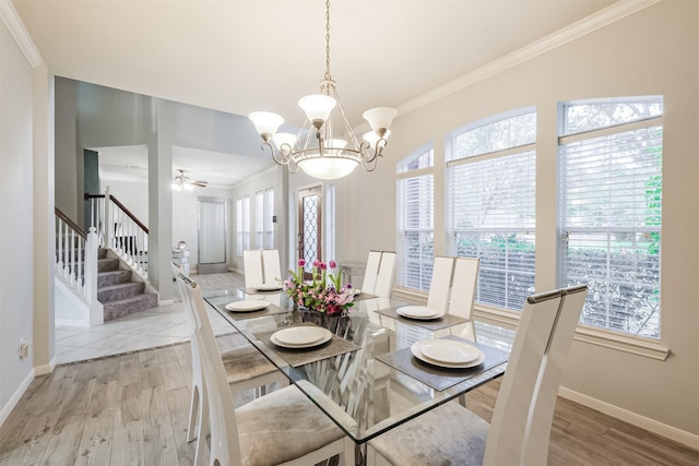 dining room featuring a healthy amount of sunlight, ceiling fan with notable chandelier, crown molding, and light hardwood / wood-style floors