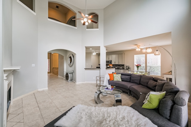 tiled living room featuring a high ceiling