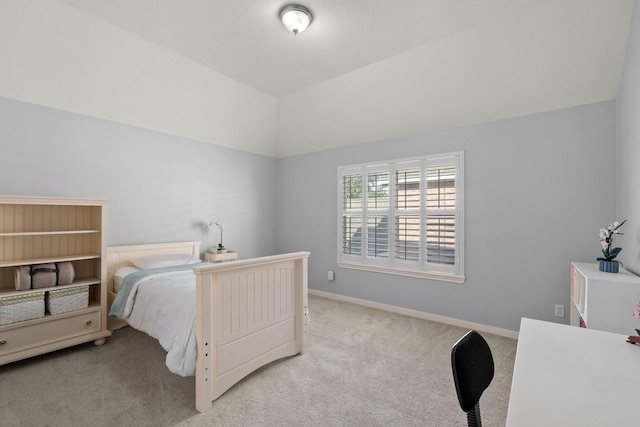 carpeted bedroom with lofted ceiling