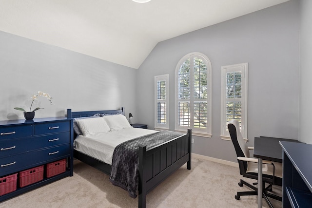 carpeted bedroom with lofted ceiling