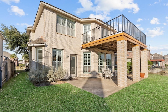 rear view of house featuring a patio area, a deck, and a lawn