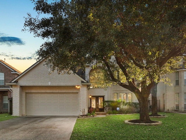 view of front of property featuring a garage and a yard