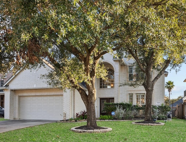 view of front of home with a garage and a front yard