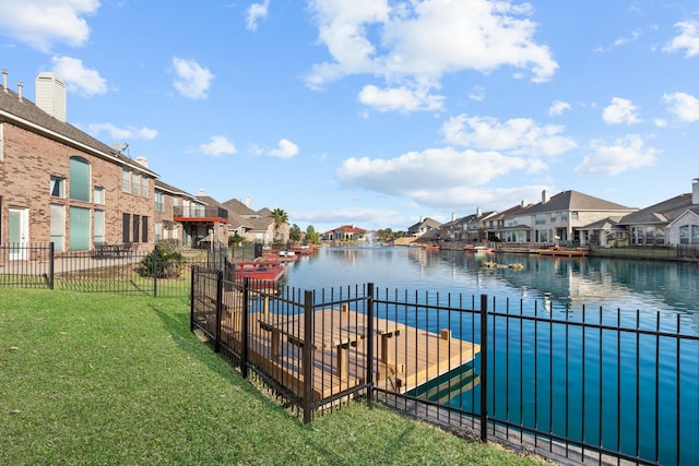 view of dock with a water view and a yard