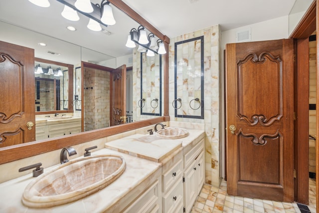 bathroom featuring an enclosed shower and vanity