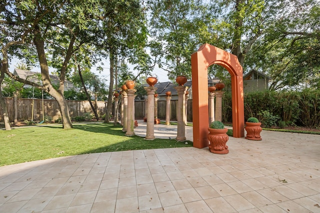 view of playground with a patio and a yard