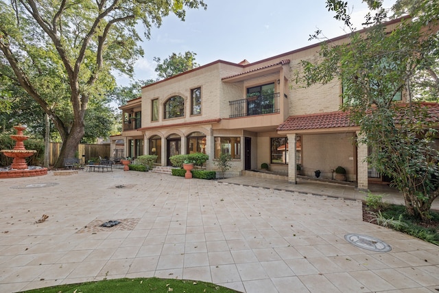 view of front of home with a patio area and a balcony