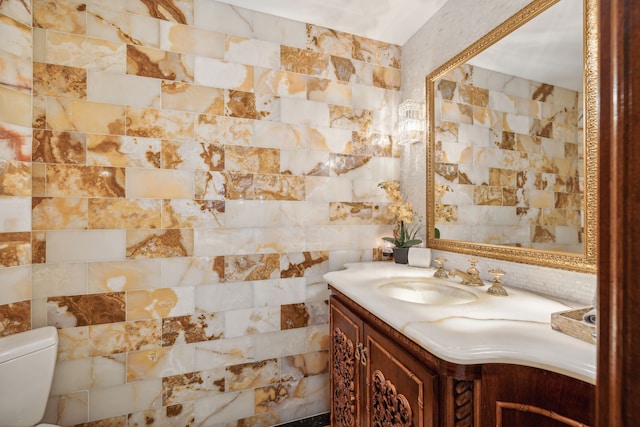 bathroom featuring tile walls, toilet, and vanity