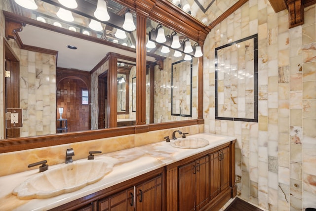 bathroom featuring tile walls, vanity, and ornamental molding