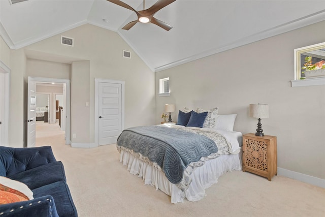 bedroom with vaulted ceiling, a closet, ornamental molding, light colored carpet, and ceiling fan