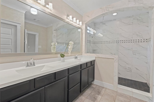 bathroom with tiled shower, crown molding, tile patterned floors, and vanity