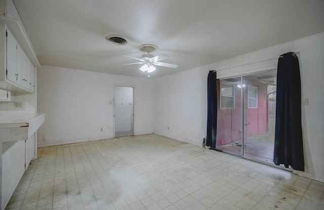 unfurnished living room featuring ceiling fan