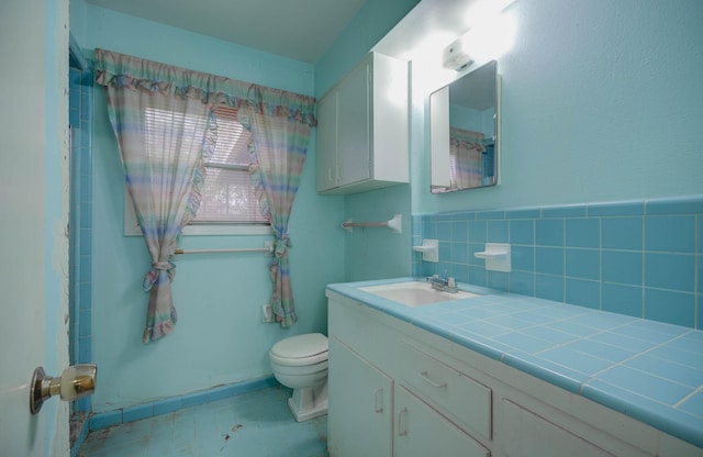 bathroom with toilet and vanity