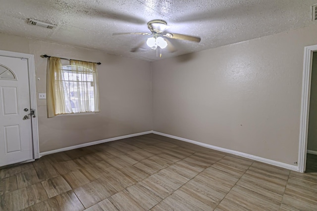 entrance foyer with ceiling fan and a textured ceiling