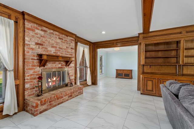 living room featuring a brick fireplace and a healthy amount of sunlight